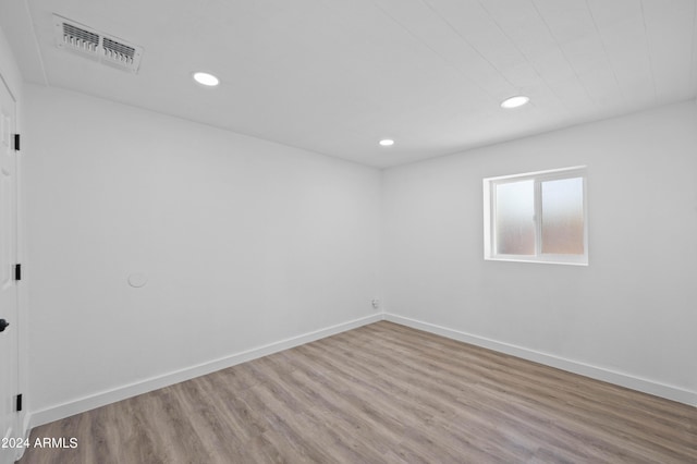 empty room with light hardwood / wood-style flooring