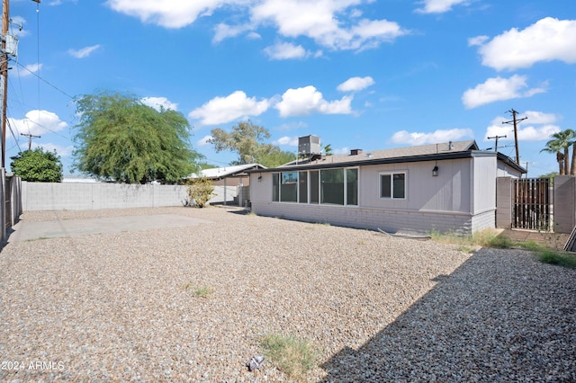 back of property with a patio area and central air condition unit