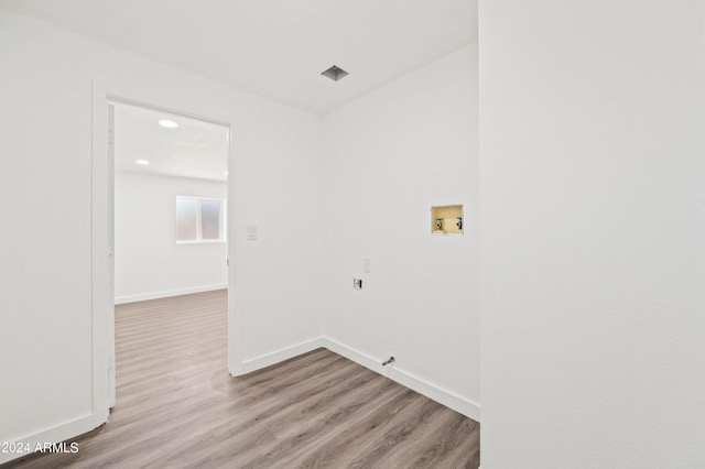 clothes washing area featuring light hardwood / wood-style floors and hookup for a washing machine