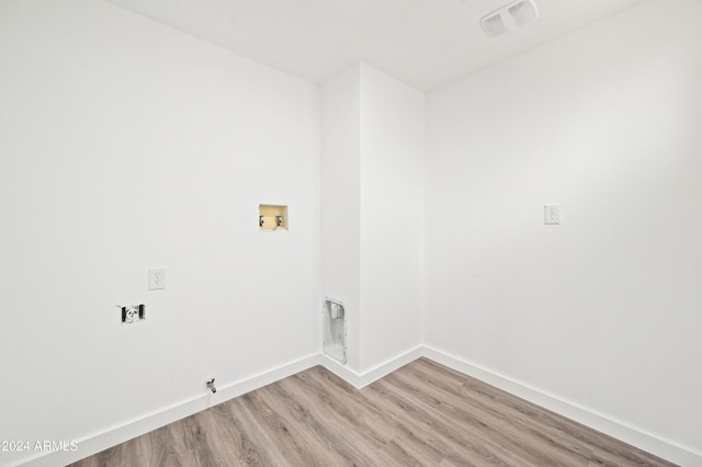 laundry area with light hardwood / wood-style floors, washer hookup, and gas dryer hookup