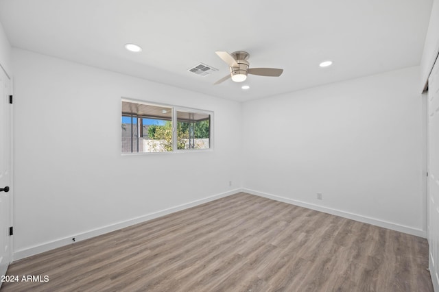 empty room with ceiling fan and light wood-type flooring