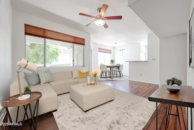 living room featuring dark hardwood / wood-style floors and ceiling fan