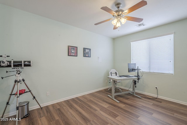 office with baseboards, ceiling fan, visible vents, and wood finished floors