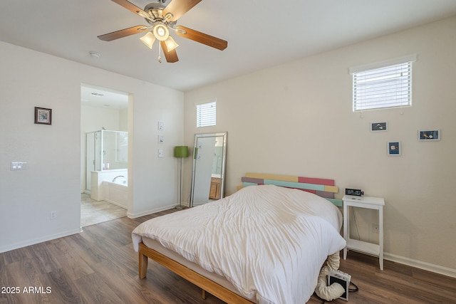 bedroom featuring ensuite bathroom, baseboards, wood finished floors, and a ceiling fan