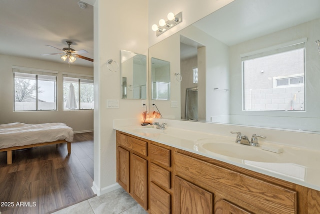 full bath with double vanity, connected bathroom, a sink, and ceiling fan