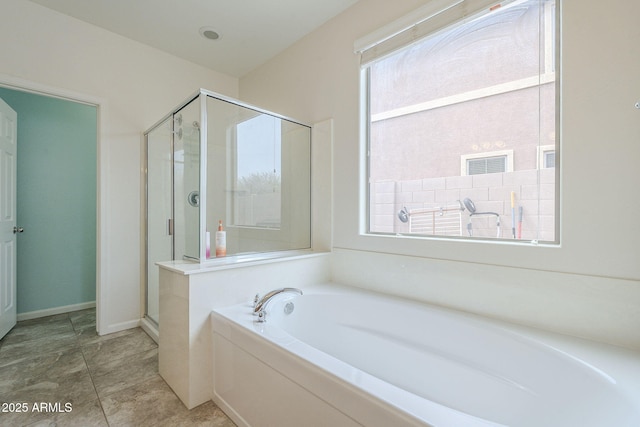full bathroom featuring a bath and a shower stall