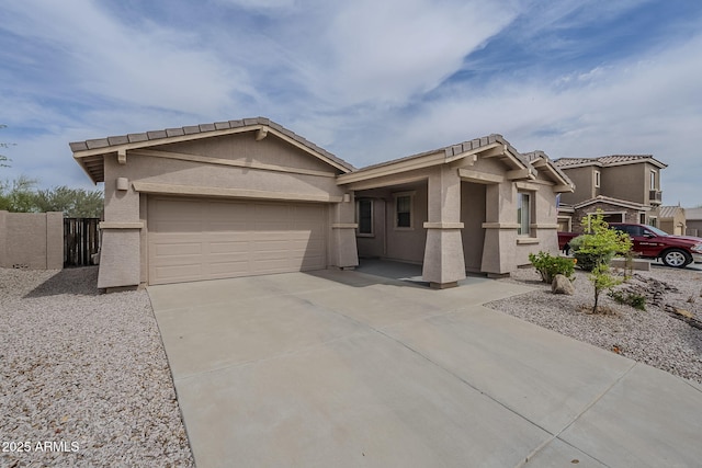 ranch-style home featuring fence, an attached garage, concrete driveway, a tile roof, and stucco siding