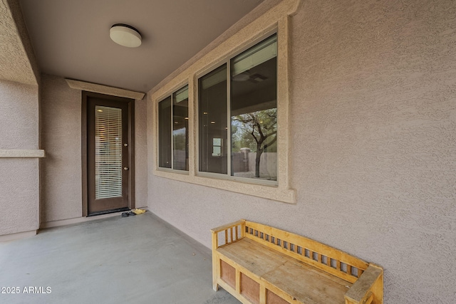 view of exterior entry with stucco siding