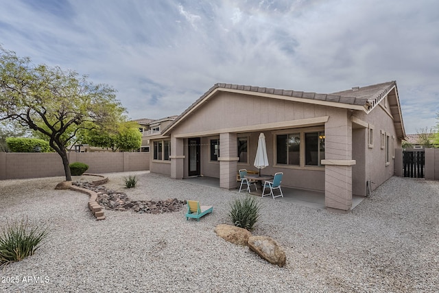 back of property featuring a fenced backyard, stucco siding, and a patio area