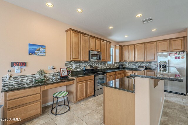 kitchen with tasteful backsplash, stainless steel appliances, dark stone countertops, a kitchen island, and visible vents