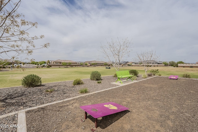 view of home's community with a yard