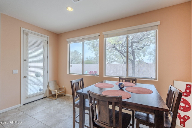 dining room with light tile patterned floors, baseboards, and recessed lighting