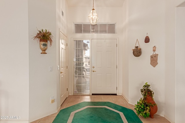 foyer entrance featuring a high ceiling and light tile patterned floors