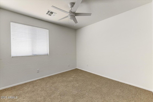 empty room with a ceiling fan, baseboards, visible vents, and carpet