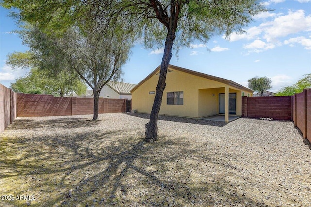 view of home's exterior with a patio, a fenced backyard, and stucco siding