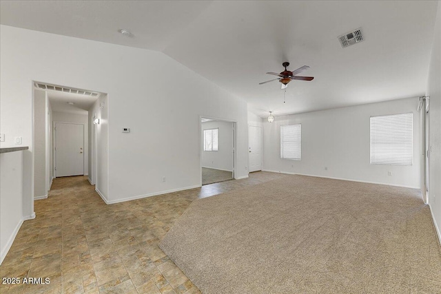unfurnished living room featuring ceiling fan, visible vents, baseboards, and vaulted ceiling