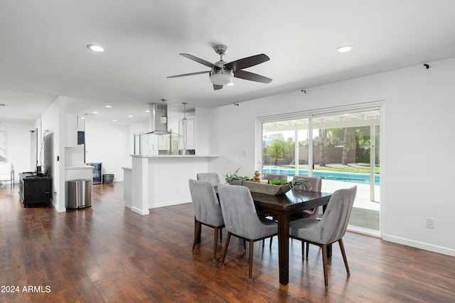 dining space with ceiling fan and dark hardwood / wood-style floors