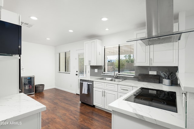 kitchen with black electric cooktop, island range hood, white cabinetry, and stainless steel dishwasher