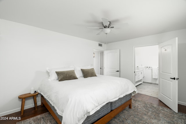 bedroom with ceiling fan, dark hardwood / wood-style floors, and connected bathroom