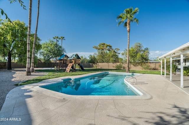 view of pool featuring a patio area and a playground