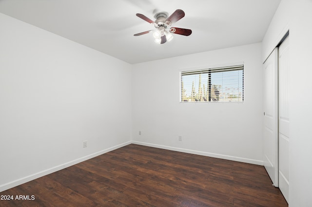 unfurnished bedroom featuring a closet, ceiling fan, and dark hardwood / wood-style flooring