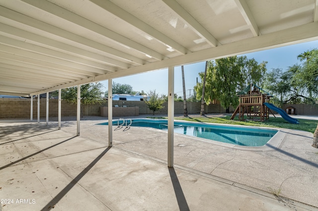 view of pool featuring a patio area and a playground