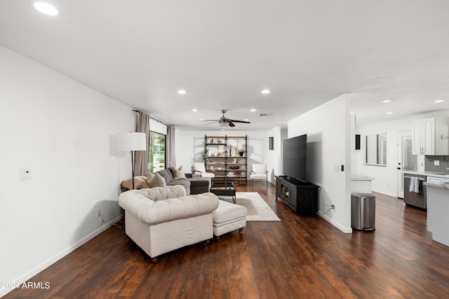 living room with ceiling fan and dark hardwood / wood-style flooring