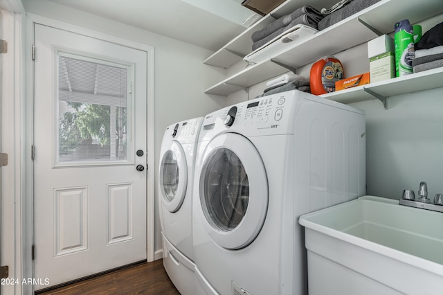 clothes washing area with dark hardwood / wood-style floors, sink, and separate washer and dryer