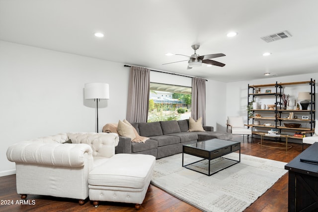 living room with dark hardwood / wood-style flooring and ceiling fan