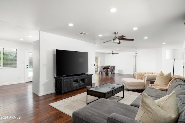 living room with ceiling fan and dark hardwood / wood-style floors