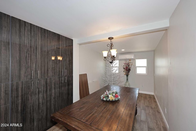 dining space featuring hardwood / wood-style floors, an inviting chandelier, and a wall mounted AC