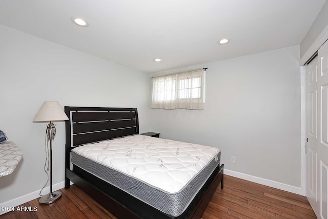 bedroom featuring dark hardwood / wood-style floors and a closet