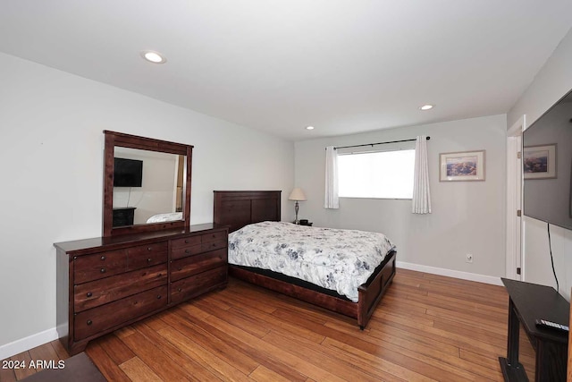 bedroom with hardwood / wood-style floors