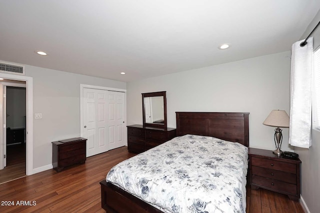 bedroom featuring dark hardwood / wood-style flooring and a closet