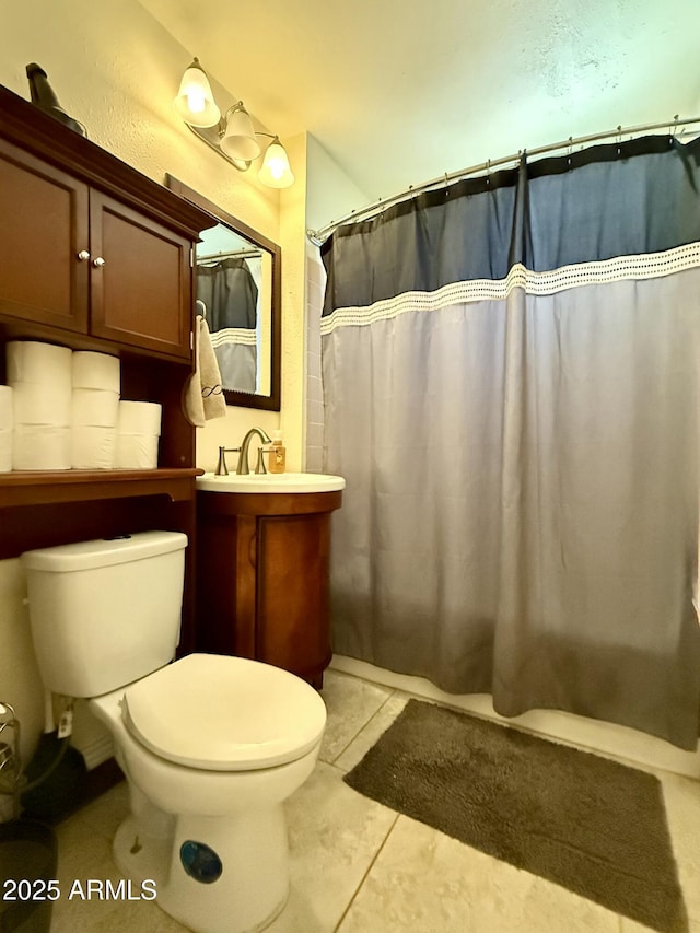 bathroom featuring vanity, curtained shower, tile patterned flooring, and toilet