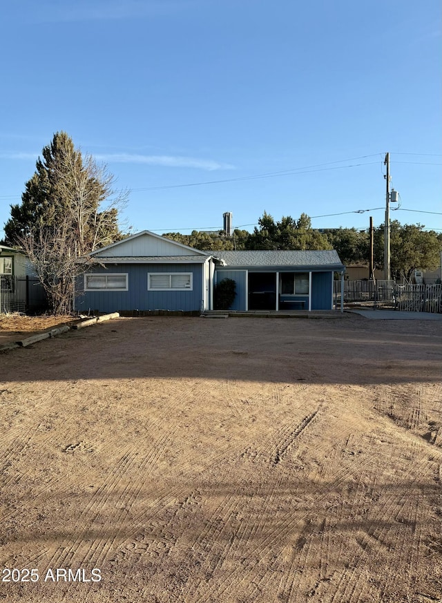 view of front of home featuring fence