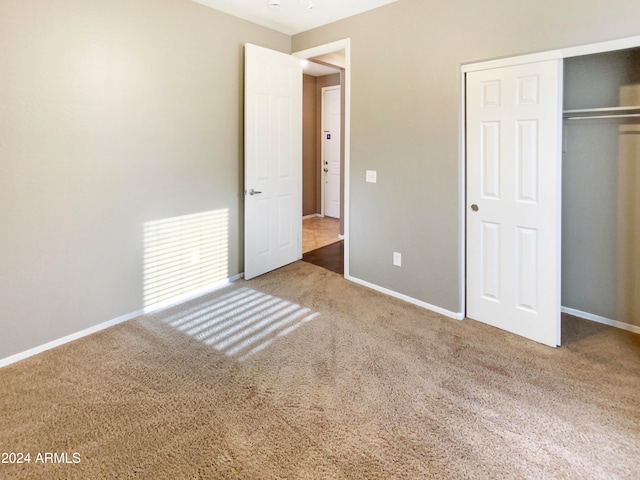 unfurnished bedroom featuring carpet floors and a closet