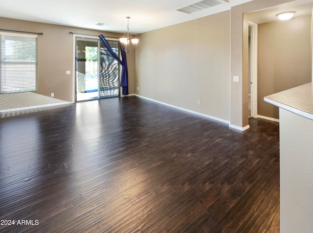 interior space with dark hardwood / wood-style floors and a notable chandelier