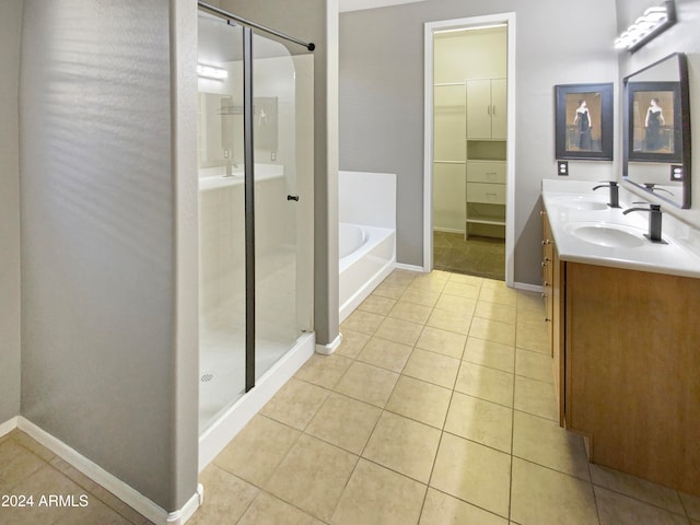 bathroom with tile patterned flooring, vanity, and plus walk in shower