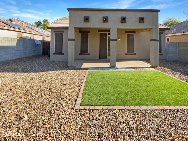 back of property featuring a patio