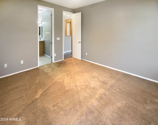 unfurnished bedroom with carpet and ensuite bath