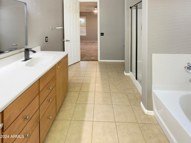 bathroom featuring tile patterned flooring, vanity, ceiling fan, and plus walk in shower