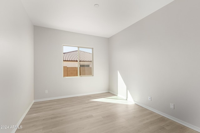 empty room with light hardwood / wood-style flooring