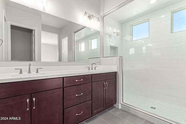 bathroom with vanity, tile patterned floors, and tiled shower