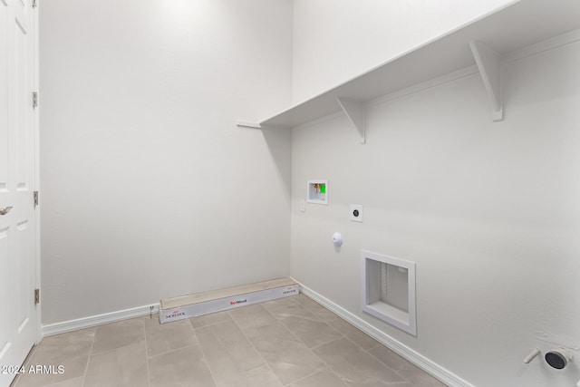 laundry room featuring hookup for an electric dryer, washer hookup, light tile patterned flooring, and hookup for a gas dryer