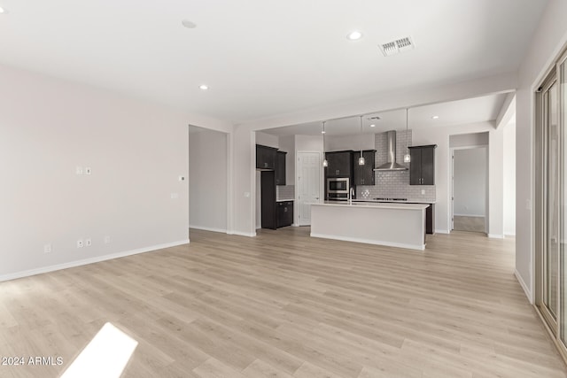 unfurnished living room featuring light hardwood / wood-style flooring and sink