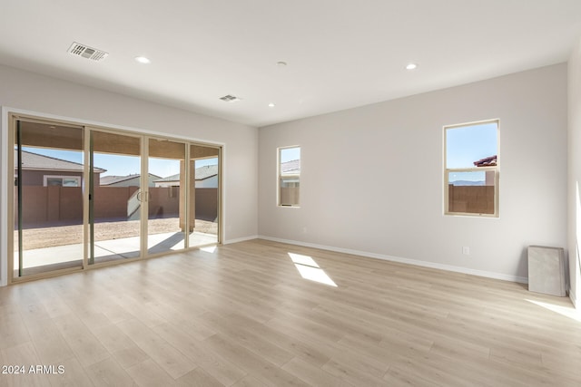 empty room featuring light wood-type flooring and a wealth of natural light