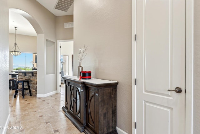 34096 N 87th Way, Scottsdale, AZ 85266 - hall featuring arched walkways, an inviting chandelier, baseboards, and visible vents