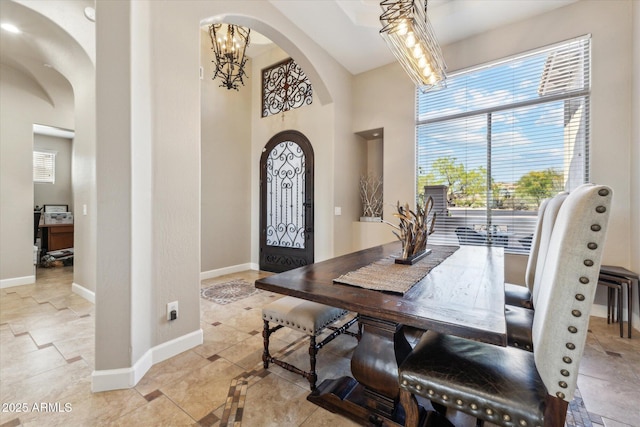 34096 N 87th Way, Scottsdale, AZ 85266 - interior space with baseboards, arched walkways, an inviting chandelier, and a high ceiling