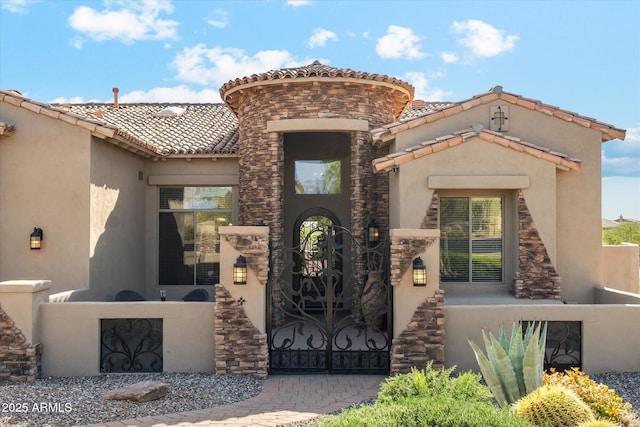 34096 N 87th Way, Scottsdale, AZ 85266 - doorway to property featuring stucco siding, a tile roof, and stone siding